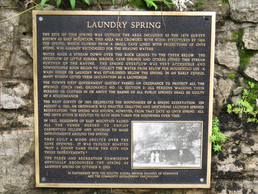 A plaque detailing the history and significance of Laundry Spring, with information about its use and local ordinances.