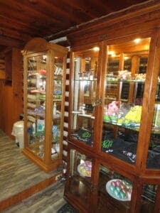 Two wooden display cabinets filled with colorful items and decorative accessories.