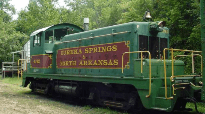 A green train locomotive with "Eureka Springs & North Arkansas" written in red.