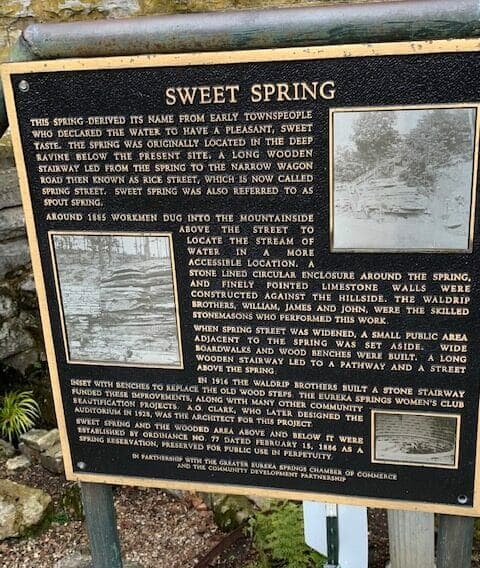 A historical plaque detailing the origins and development of Sweet Spring.