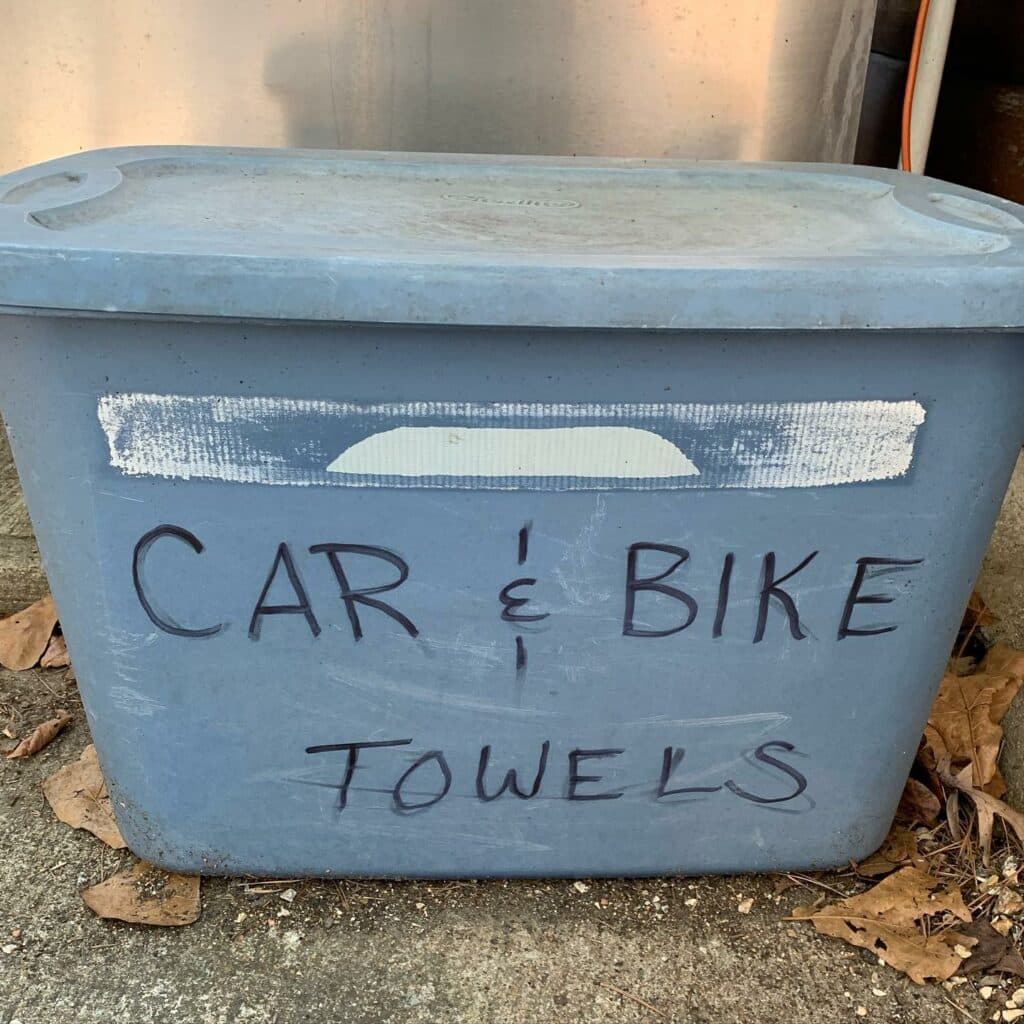 A blue storage bin labeled "CAR & BIKE TOWELS."