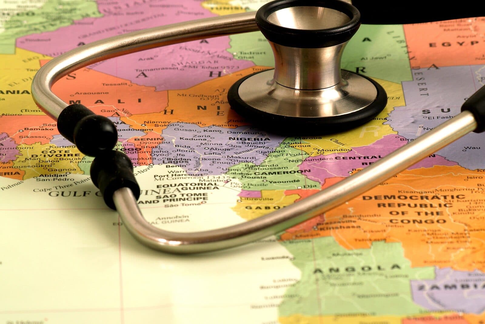 A stethoscope rests on a colorful map of Africa. A stethoscope rests on a colorful map of Africa.