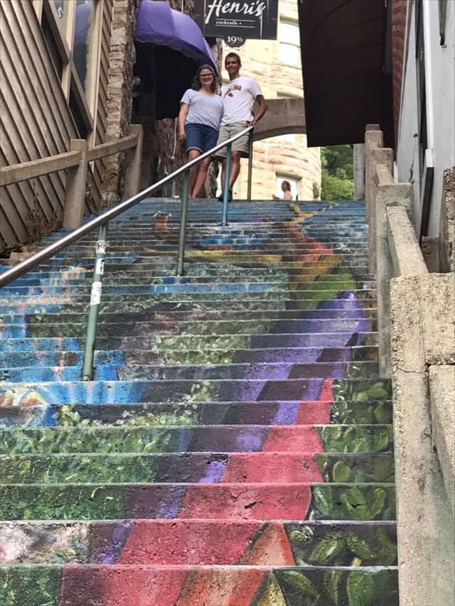 Colorful rainbow steps and two people at the top looking down