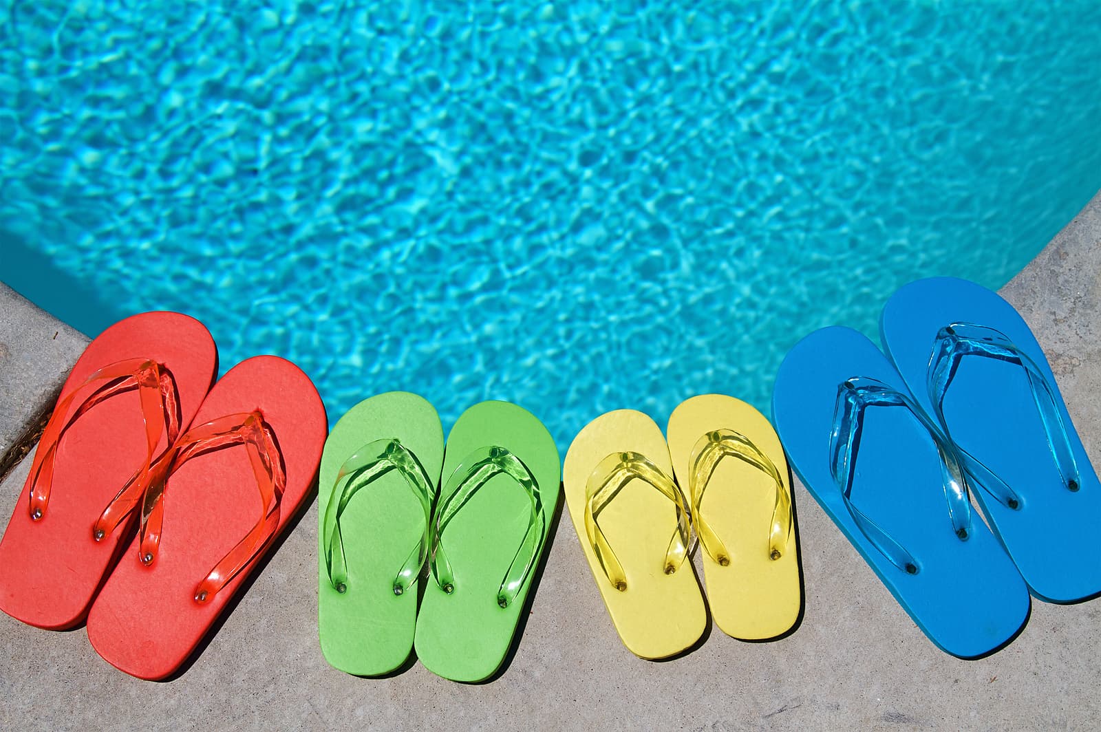 swimming pool with flip flops sitting by the pool